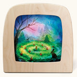 Toverlux magic lamp with a Advent candle green silhouette by artist Vogel Geluk. A watercolour style illustration of an advent candle scene set up on a forest floor surrounded by shadows of forest animals and a Christmas tree in the background.. A range of Toverlux silhouettes, lamps and accessories are available at Babipur. 