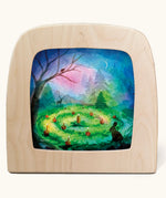 Toverlux magic lamp with a Advent candle green silhouette by artist Vogel Geluk. A watercolour style illustration of an advent candle scene set up on a forest floor surrounded by shadows of forest animals and a Christmas tree in the background.. A range of Toverlux silhouettes, lamps and accessories are available at Babipur. 