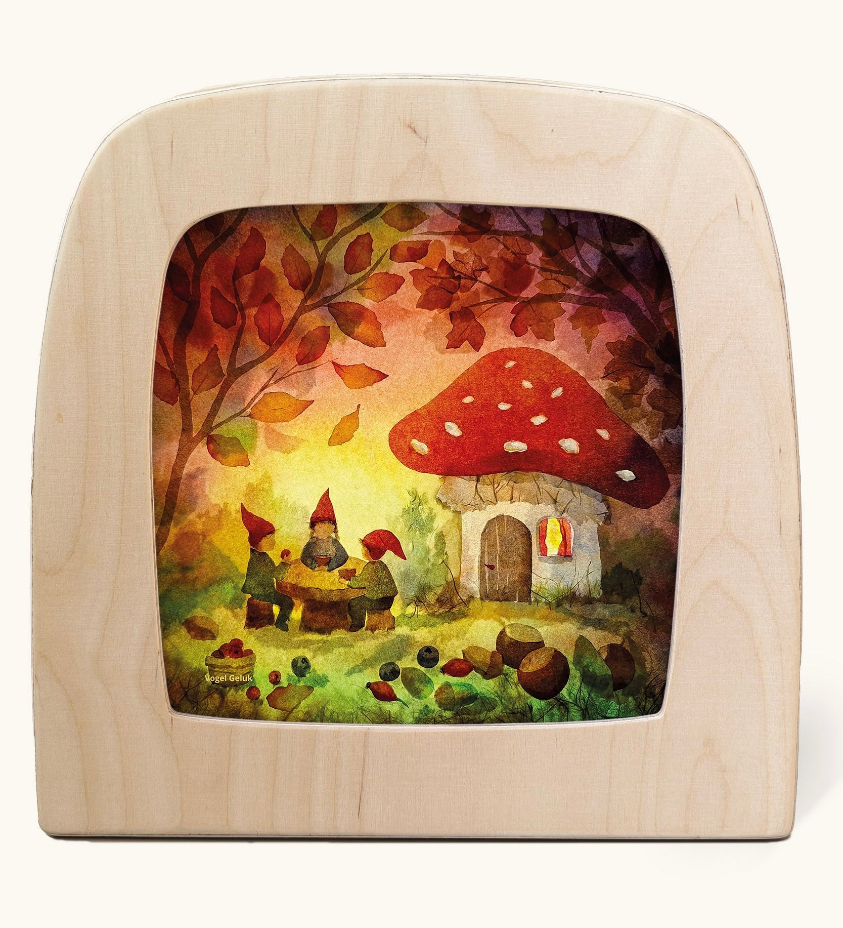 Toverlux magic lamp with a Autumn gnome toadstool picnic silhouette by artist Vogel Geluk. A watercolour style illustration of a toadstool house in a forest with a table with three gnomes sat around it. A range of Toverlux silhouettes, lamps and accessories are available at Babipur. 