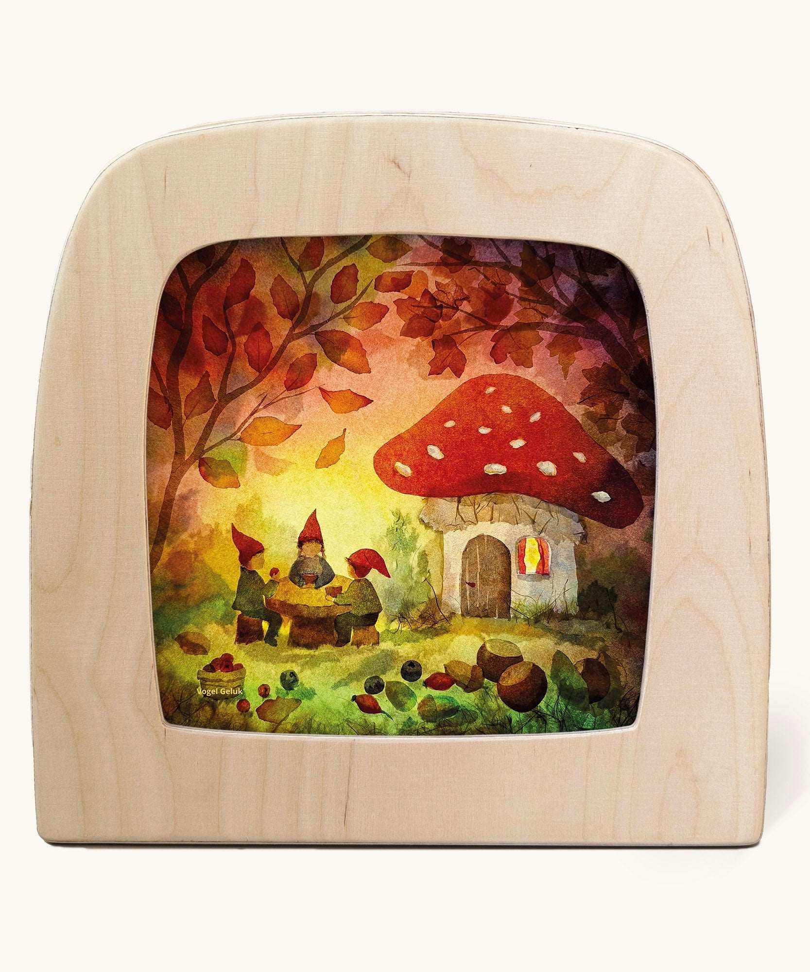 Toverlux magic lamp with a Autumn gnome toadstool picnic silhouette by artist Vogel Geluk. A watercolour style illustration of a toadstool house in a forest with a table with three gnomes sat around it. A range of Toverlux silhouettes, lamps and accessories are available at Babipur. 