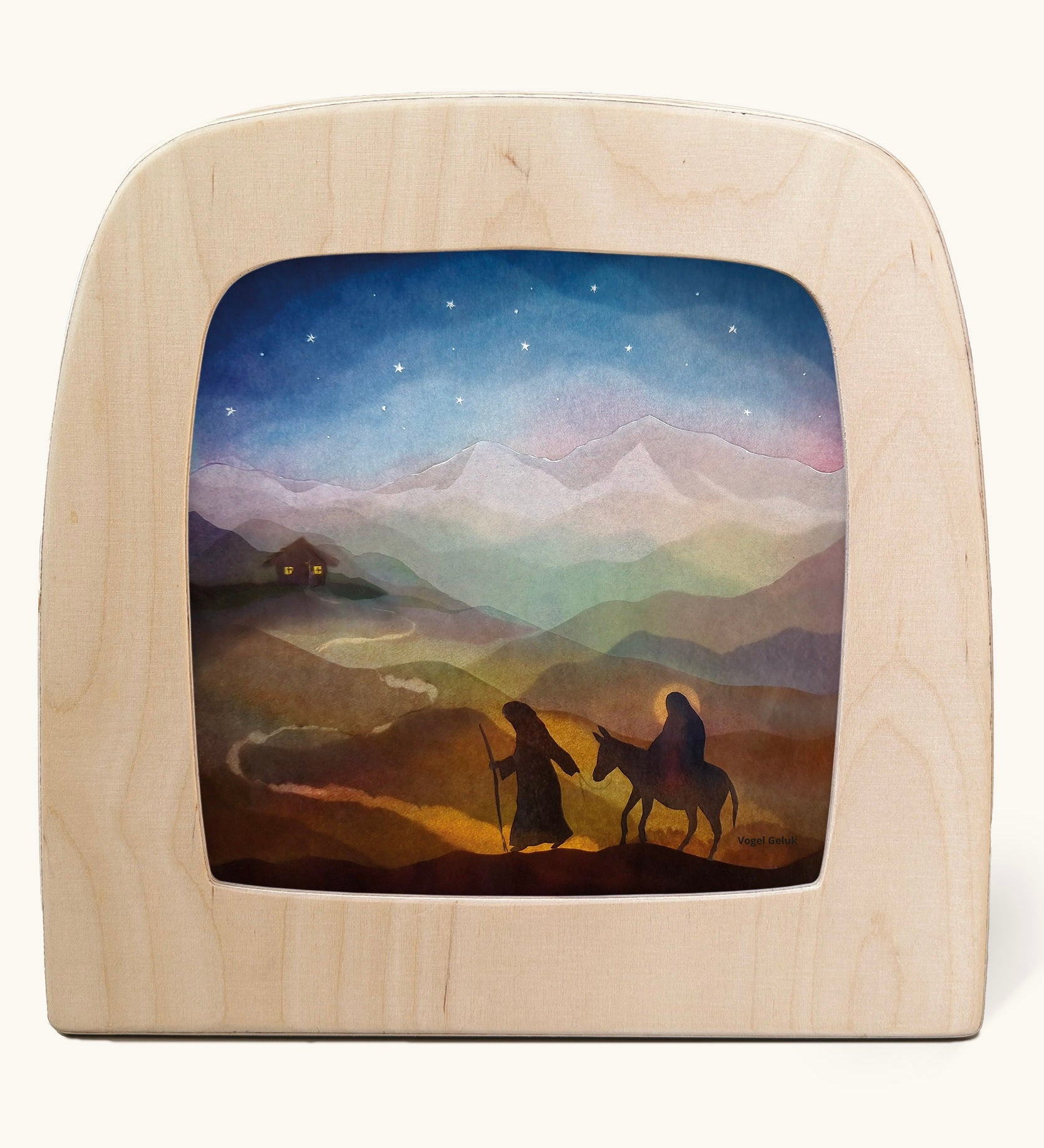 Toverlux magic lamp with a starry night pilgrimage silhouette by artist Vogel Geluk. A watercolour style illustration of Mary, Joseph and teh donkey traveling along a path under a starry sky. A range of Toverlux silhouettes, lamps and accessories are available at Babipur. 
