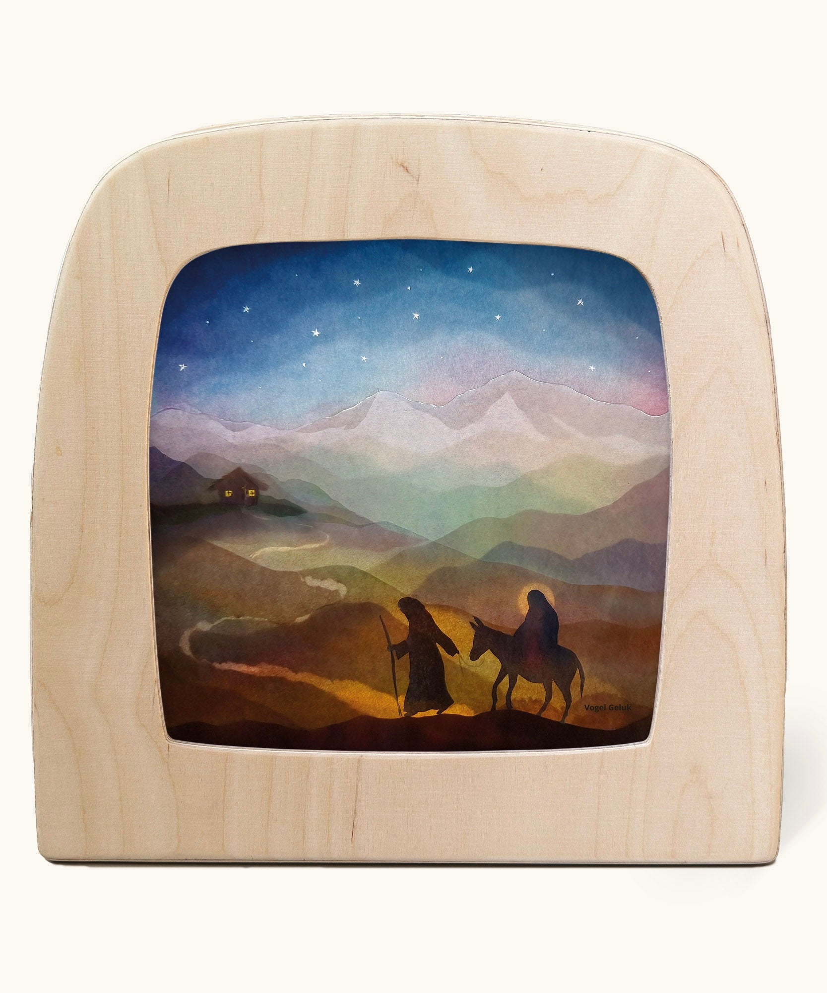Toverlux magic lamp with a starry night pilgrimage silhouette by artist Vogel Geluk. A watercolour style illustration of Mary, Joseph and teh donkey traveling along a path under a starry sky. A range of Toverlux silhouettes, lamps and accessories are available at Babipur. 