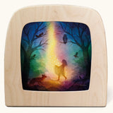 Toverlux magic lamp with a star money forest fairy silhouette by artist Vogel Geluk. A watercolour style illustration of a magical scene featuring a fairy standing in a forest with a ray of starry light shining down on her. A range of Toverlux silhouettes, lamps and accessories are available at Babipur. 