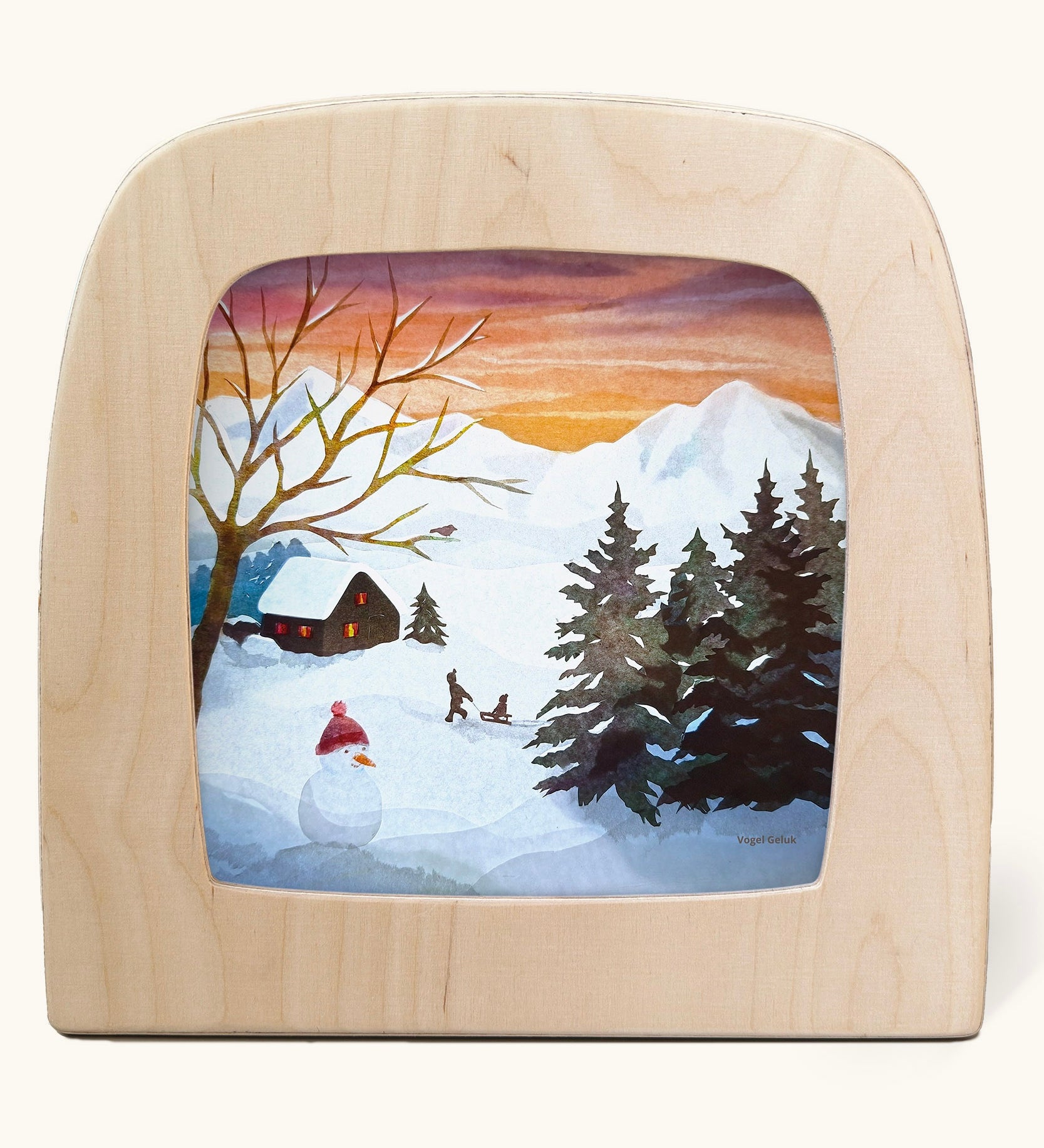 Toverlux magic lamp with a Winter sled song silhouette by artist Vogel Geluk. A watercolour style illustration of a snow covered Winter scene. There is a snowman and children on a sled in the background along with a cosy cottage in the distance. A range of Toverlux silhouettes, lamps and accessories are available at Babipur. 