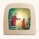 A Toverlux silhouette from artist Daniella Drescher, compatible with the Magic Lamp or Magic Frame both available at Babipur. Silhouette is showing a illustration of Santa Clause gifting a fairy