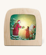 A Toverlux silhouette from artist Daniella Drescher, compatible with the Magic Lamp or Magic Frame both available at Babipur. Silhouette is showing a illustration of Santa Clause gifting a fairy
