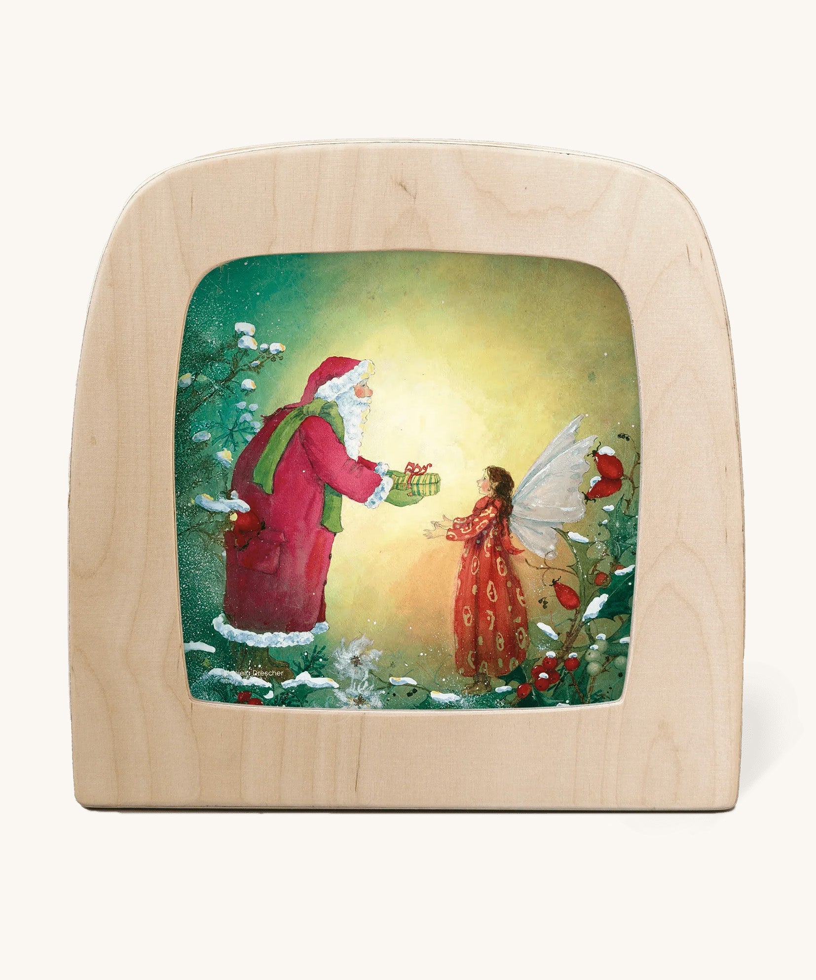 A Toverlux silhouette from artist Daniella Drescher, compatible with the Magic Lamp or Magic Frame both available at Babipur. Silhouette is showing a illustration of Santa Clause gifting a fairy