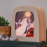 Toverlux Magic Kids Night Lamp featuring art work by Tijana Draws, the Sprit of Spring, a lady with a cloak wondering through a forest at night during a full moon.