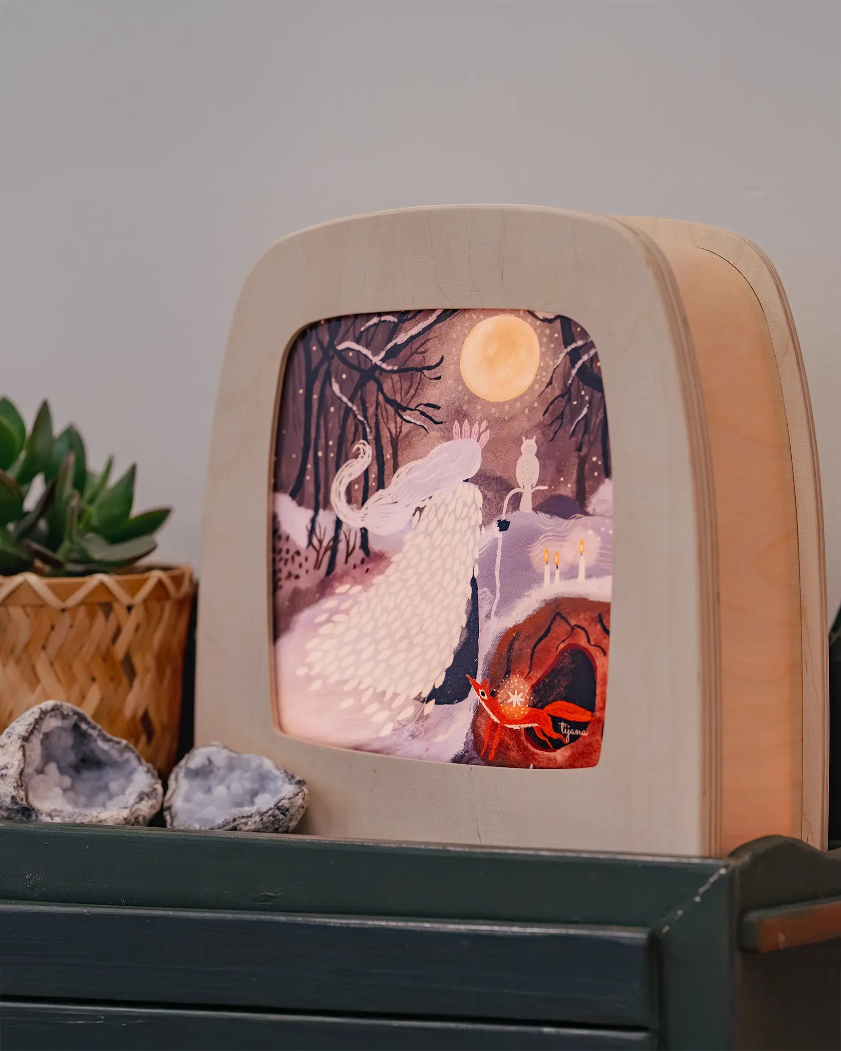 Toverlux Magic Kids Night Lamp featuring art work by Tijana Draws, the Sprit of Spring, a lady with a cloak wondering through a forest at night during a full moon.