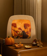 Toverlux Magic Lamp with autumn toadstool artwork by Het Wol Feetje on bedside table with walnuts.