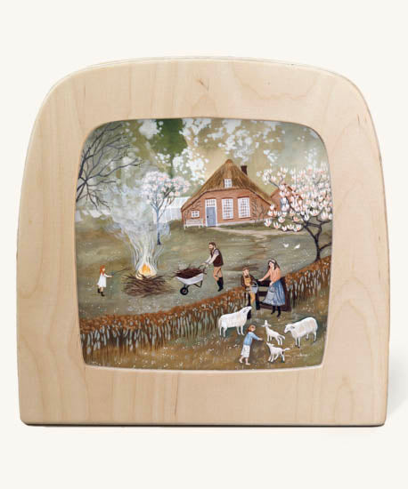 Bonfire Toverlux Magic Lamp silhouette inside a wooden magic lamp. Artwork By Robin-Pieterse. A delicate painting style illustration of a family outside with the father with a wheelbarrow filled with food for a fire. This silhouette is available at Babipur
