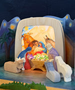 Toverlux nativity scene layered advent story silhouettes in a wooden light frame and surrounded by various Ostheimer wooden nativity figures