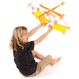 Child holding a helicopter made from various wooden poles and blocks from the Trigonos mini large construction set 