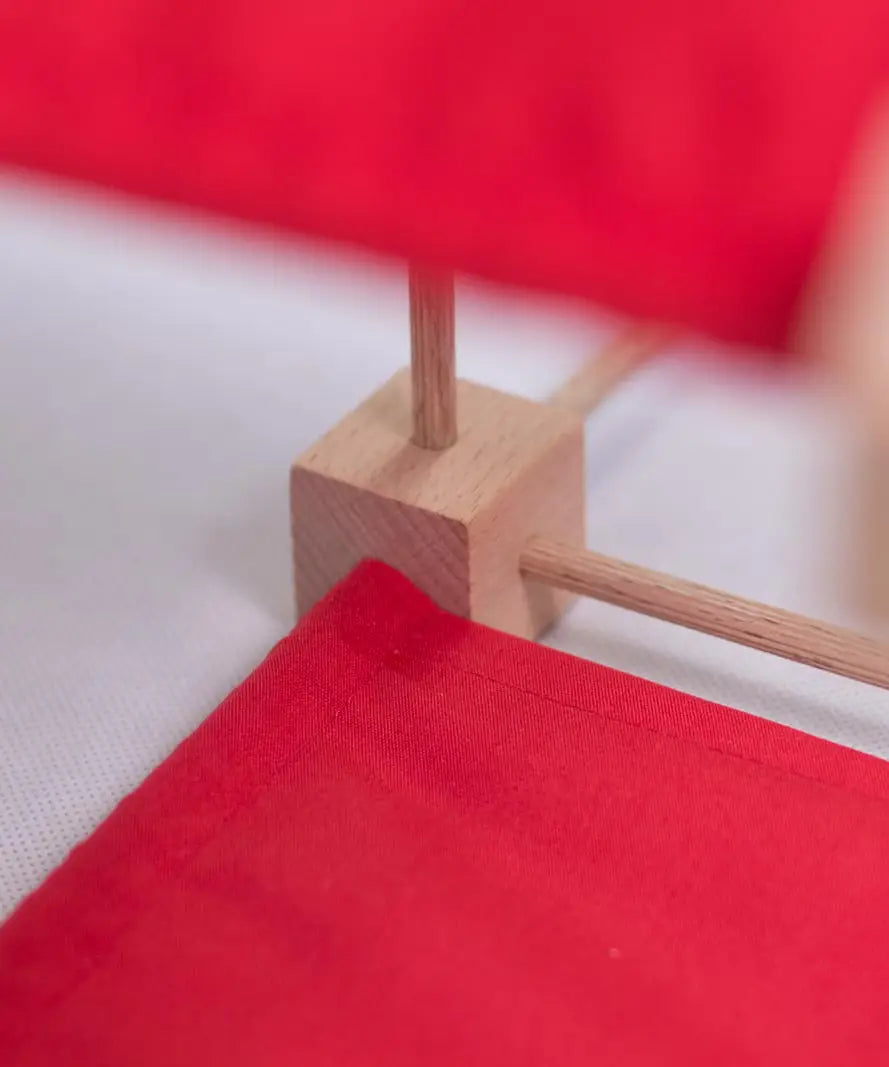 Wooden poles in a corner block of a structure made from the Trigons mini construction set