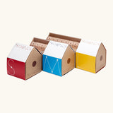 A collection of Trigonos construction sets in their cardboard packaging shaped like a house