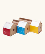 A collection of Trigonos construction sets in their cardboard packaging shaped like a house