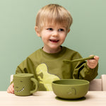 Child eating from the Trixie Animal Friends Silicone Suction Bowl, green, Mr Dino.