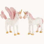 The Green Rubber Toys Rainbow Unicorn and Pegasus is a 2-pack of natural rubber, eco-friendly toy mythical horse figures with white bodies and pink details on the wings, tails and mane and golden hooves and horns. The image is on a cream background