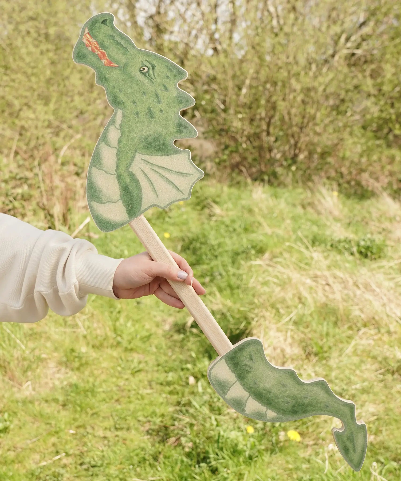 VAH wooden dragon hobby horse toy in green, fire-breathing, with a pointed tail.