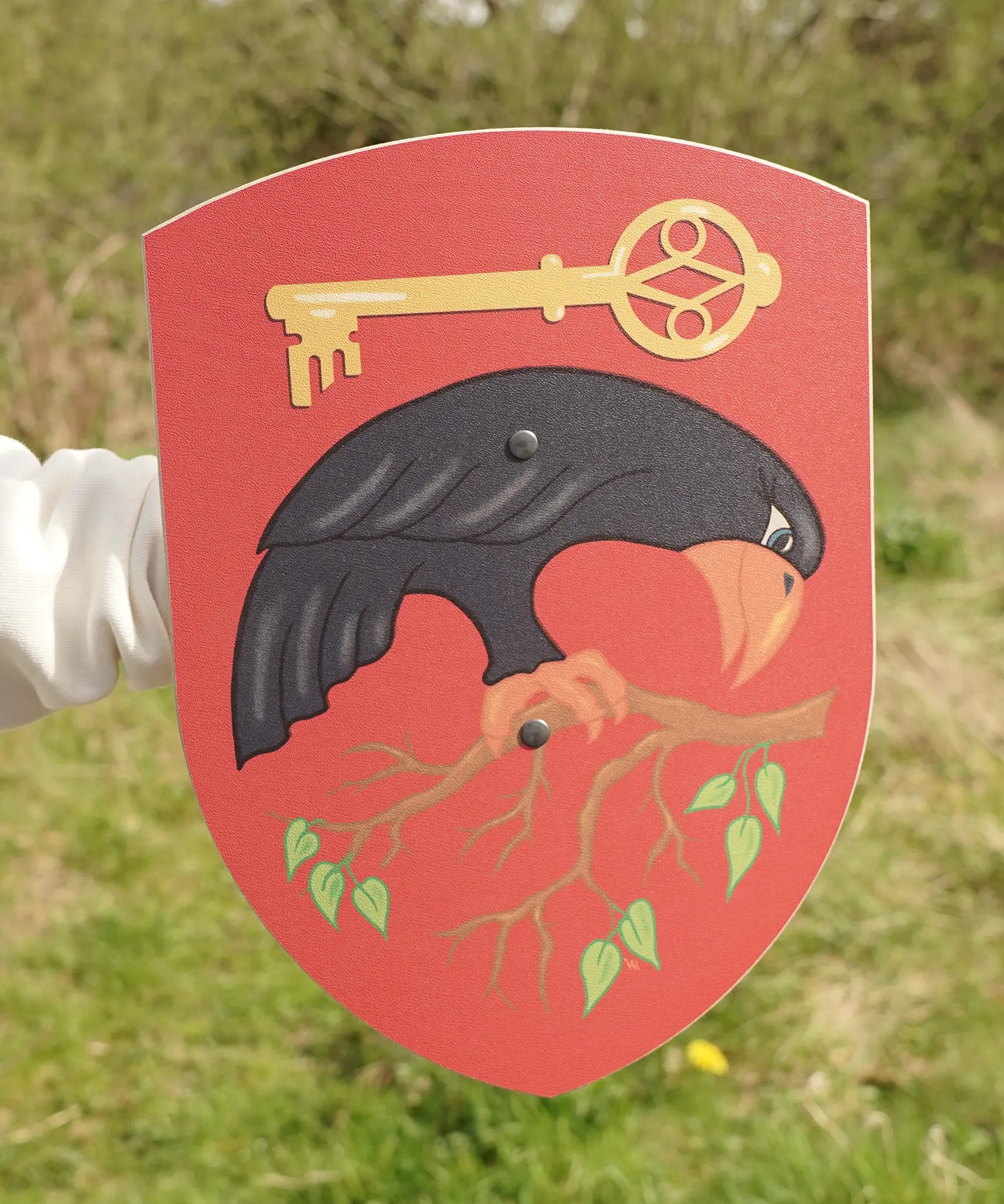 VAH Crovus toy shield, wooden with a crow, key and branch on red background, for battle dress up.