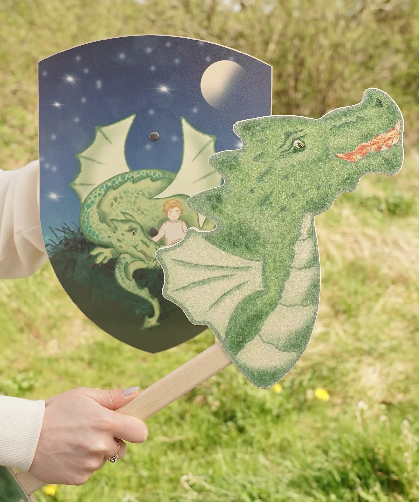 VAH wooden dragon hobby horse toy in green, fire-breathing, with Mika toy shield in blue.