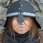 Child wearing Knight Helmet outdoors in play
