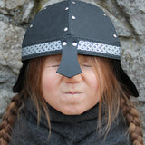 Child wearing Knight Helmet outdoors in play