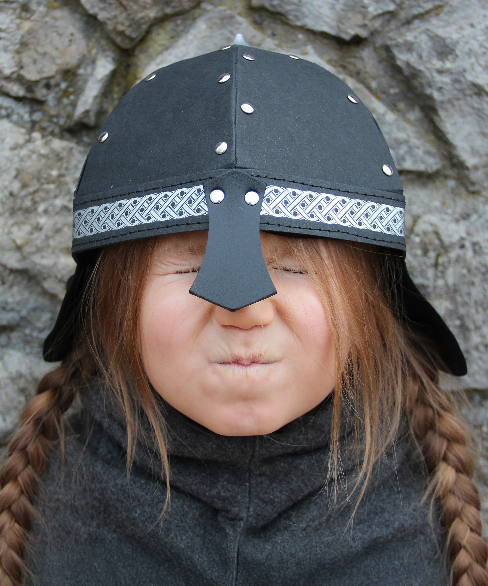 Child wearing Knight Helmet outdoors in play