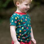 A child happily outside, wearing the LGR Vegetable Patch Short Sleeve T-Shirt