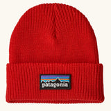 Patagonia Kids Logo Beanie in Sizzle Red. Bright Red Rib knit with a folded cuff and classic Patagonia p-6 logo patch sewn onto the front.