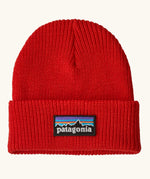 Patagonia Kids Logo Beanie in Sizzle Red. Bright Red Rib knit with a folded cuff and classic Patagonia p-6 logo patch sewn onto the front.