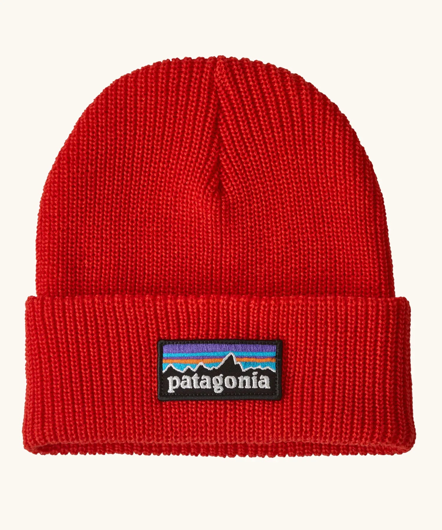 Patagonia Kids Logo Beanie in Sizzle Red. Bright Red Rib knit with a folded cuff and classic Patagonia p-6 logo patch sewn onto the front.