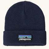 Patagonia Kids Logo Beanie in New Navy. Blue Rib knit with a folded cuff and classic Patagonia p-6 logo patch sewn onto the front.