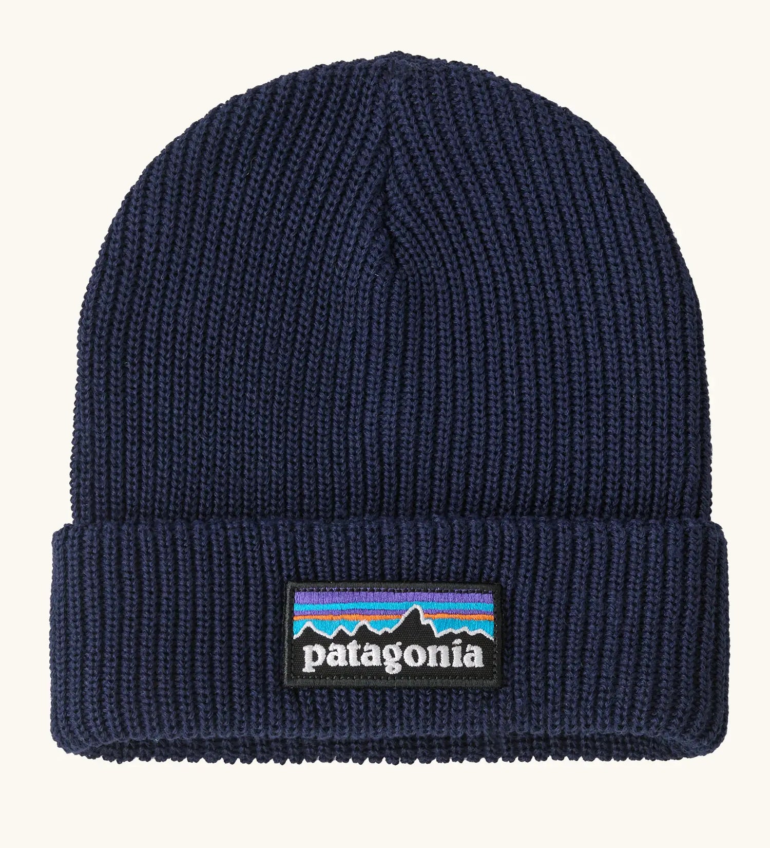 Patagonia Kids Logo Beanie in New Navy. Blue Rib knit with a folded cuff and classic Patagonia p-6 logo patch sewn onto the front.