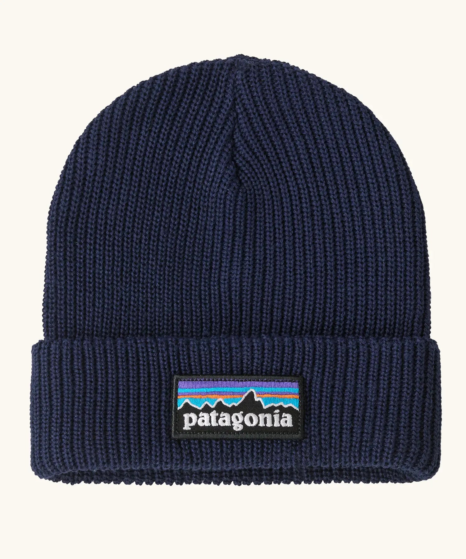 Patagonia Kids Logo Beanie in New Navy. Blue Rib knit with a folded cuff and classic Patagonia p-6 logo patch sewn onto the front.
