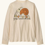 Patagonia Kids organic Long-Sleeved Graphic T-Shirt in Nature's Pace: Undyed Natural. A Beige body with vintage-style Patagonia “Nature’s Pace” snail graphic on the back.