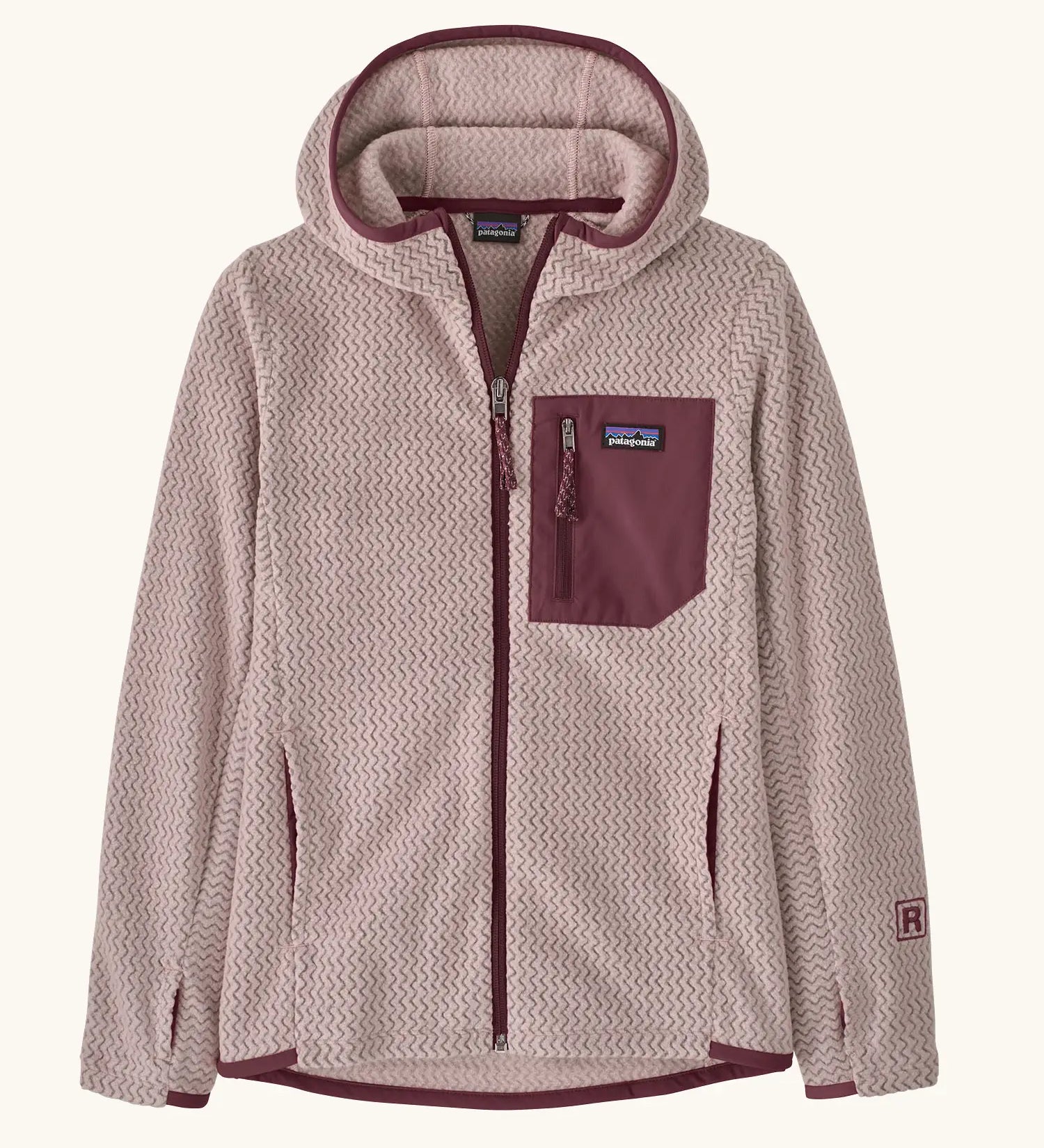 Patagonia Kids’ R1 Air Full-Zip Hoody in Pink Frost. Pale pink ribbed body with contrasting maroon binding and square chest pocket, with thumb holes.