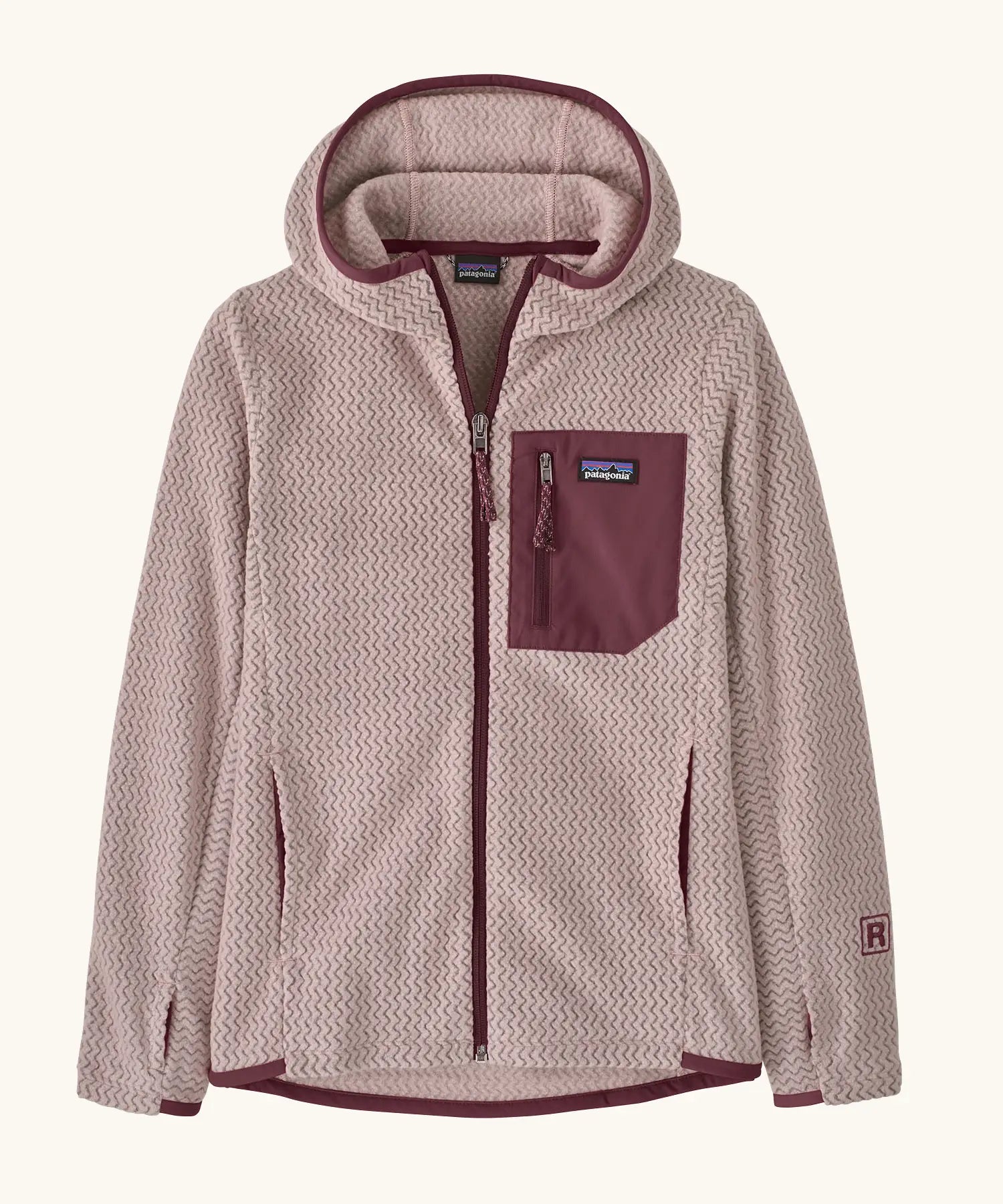 Patagonia Kids’ R1 Air Full-Zip Hoody in Pink Frost. Pale pink ribbed body with contrasting maroon binding and square chest pocket, with thumb holes.