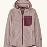 Patagonia Kids’ R1 Air Full-Zip Hoody in Pink Frost. Pale pink ribbed body with contrasting maroon binding and square chest pocket, with thumb holes.