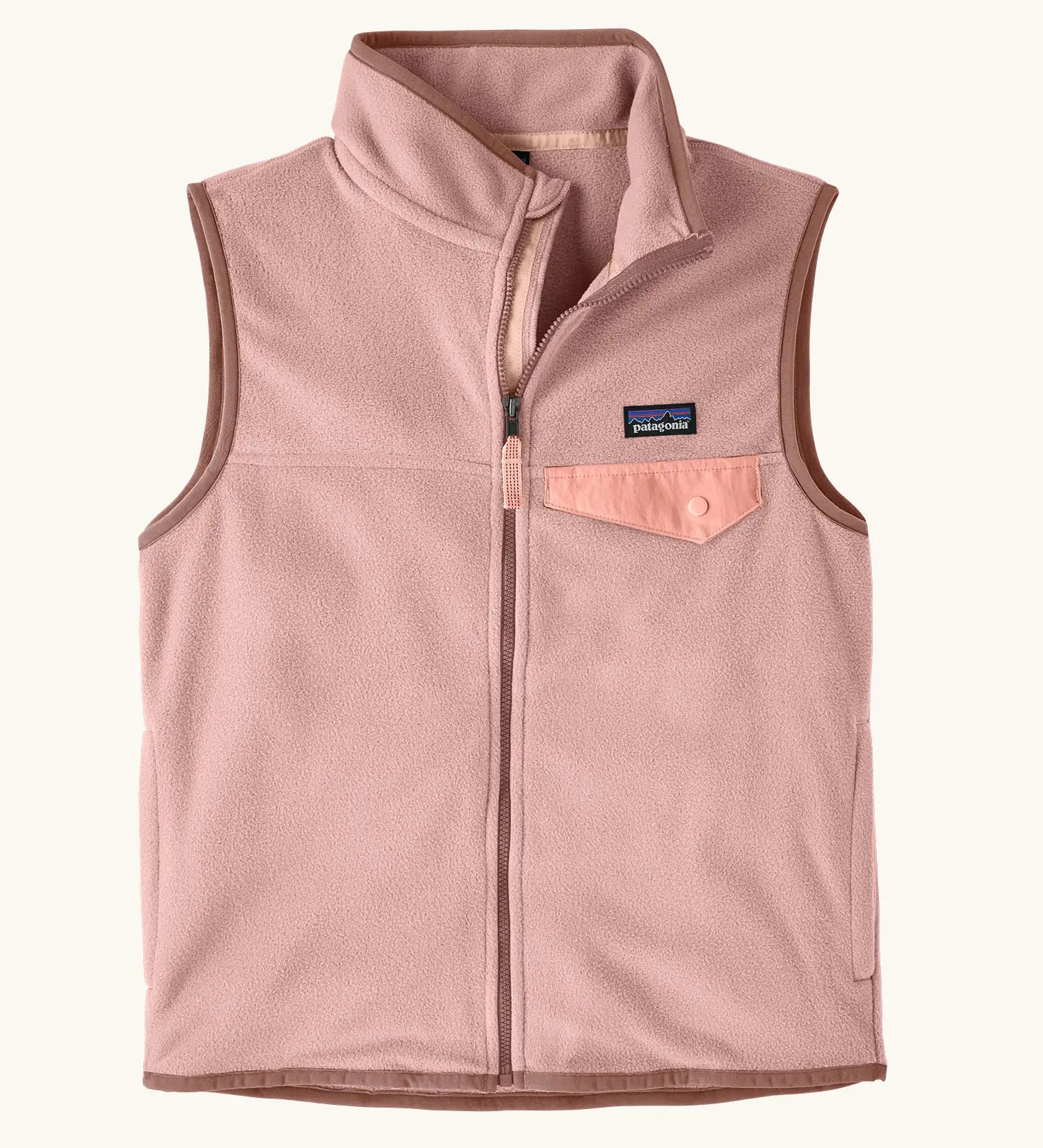 Patagonia Kids Micro D Snap-T Fleece Vest in Fuzzy Mauve. Pale pink fleece body and soft brown binding with a matching chest pocket flap.