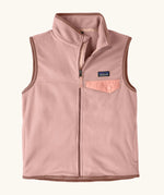Patagonia Kids Micro D Snap-T Fleece Vest in Fuzzy Mauve. Pale pink fleece body and soft brown binding with a matching chest pocket flap.