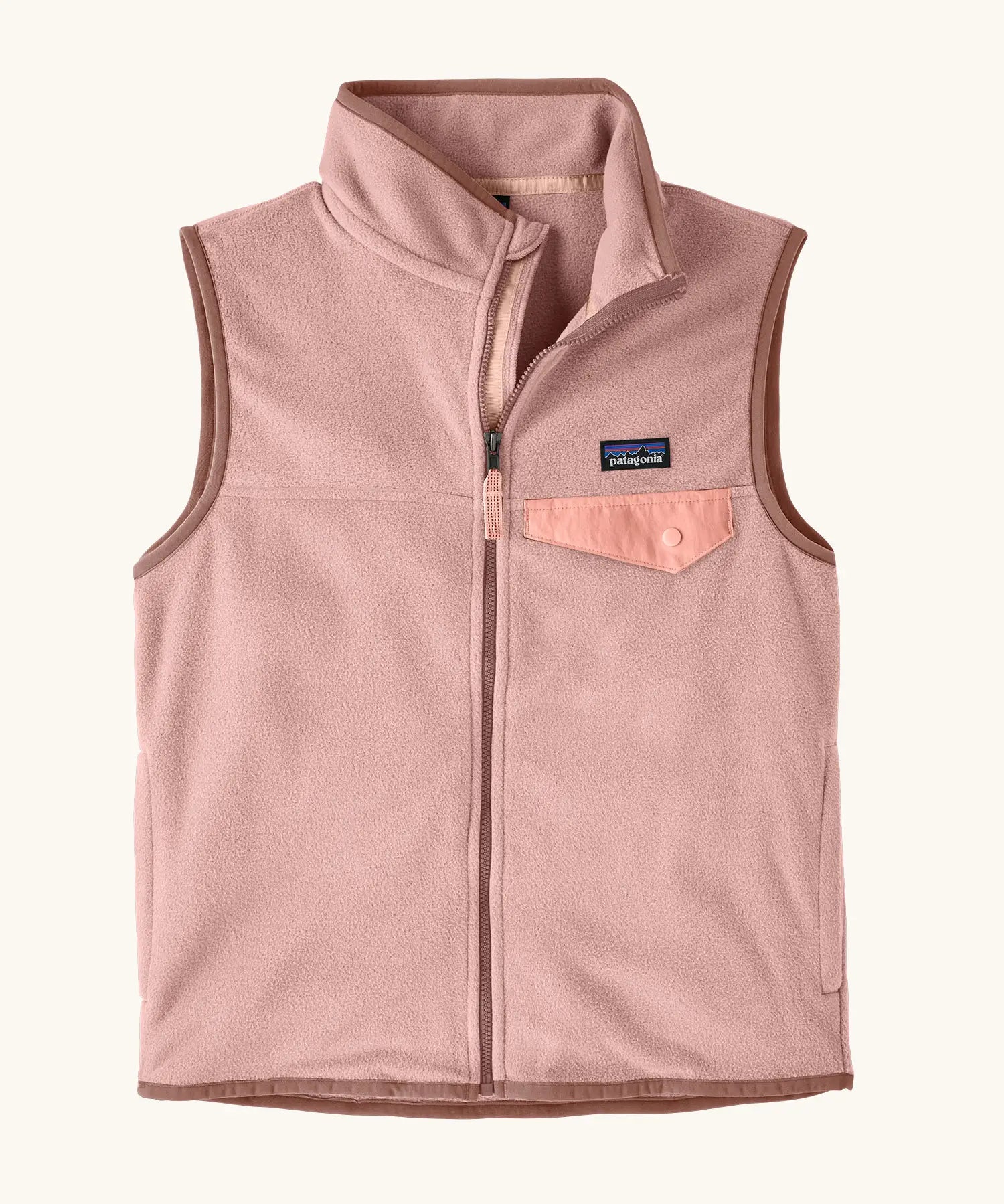 Patagonia Kids Micro D Snap-T Fleece Vest in Fuzzy Mauve. Pale pink fleece body and soft brown binding with a matching chest pocket flap.