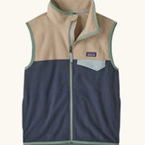 Patagonia Kids Micro D Snap-T Fleece Vest in Smolder Blue with Oar Tan. Navy blue lower body panel, camel beige upper panel, and sage green binding with a matching chest pocket flap.