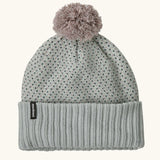 Patagonia Kids Powder Town Beanie in Confetti: virtually blue. A Light grey knit with pink and navy dots, a rib knit cuff, and a pale pink pom-pom on top. With a small vertical Patagonia logo on the cuff.
