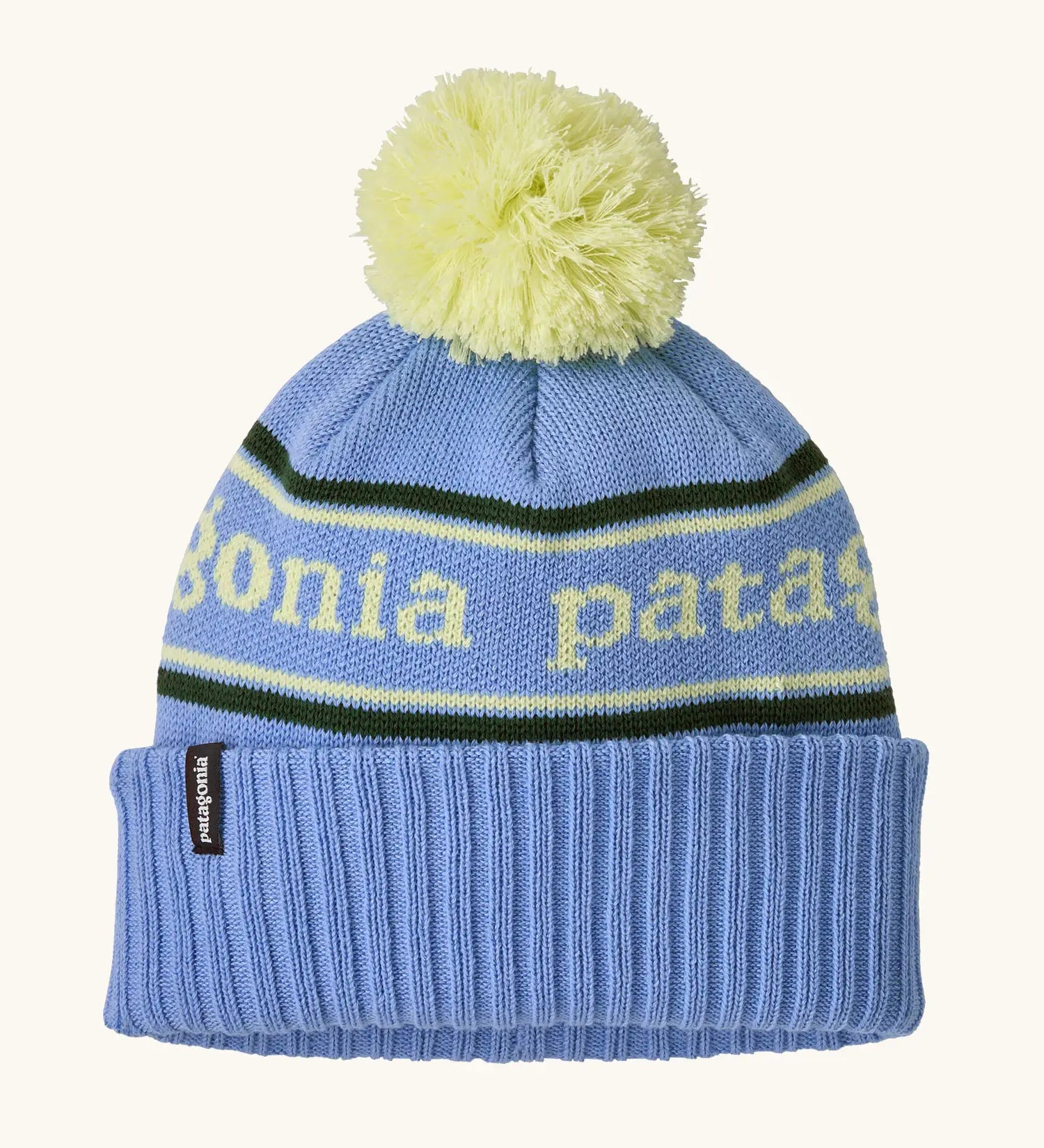 Patagonia Kids Powder Town Beanie in Park Stripe: Diver Blue. A pale blue knit with lime green 'Patagonia' woven around the head, a rib-knit cuff, and a lime green pom-pom on top. 