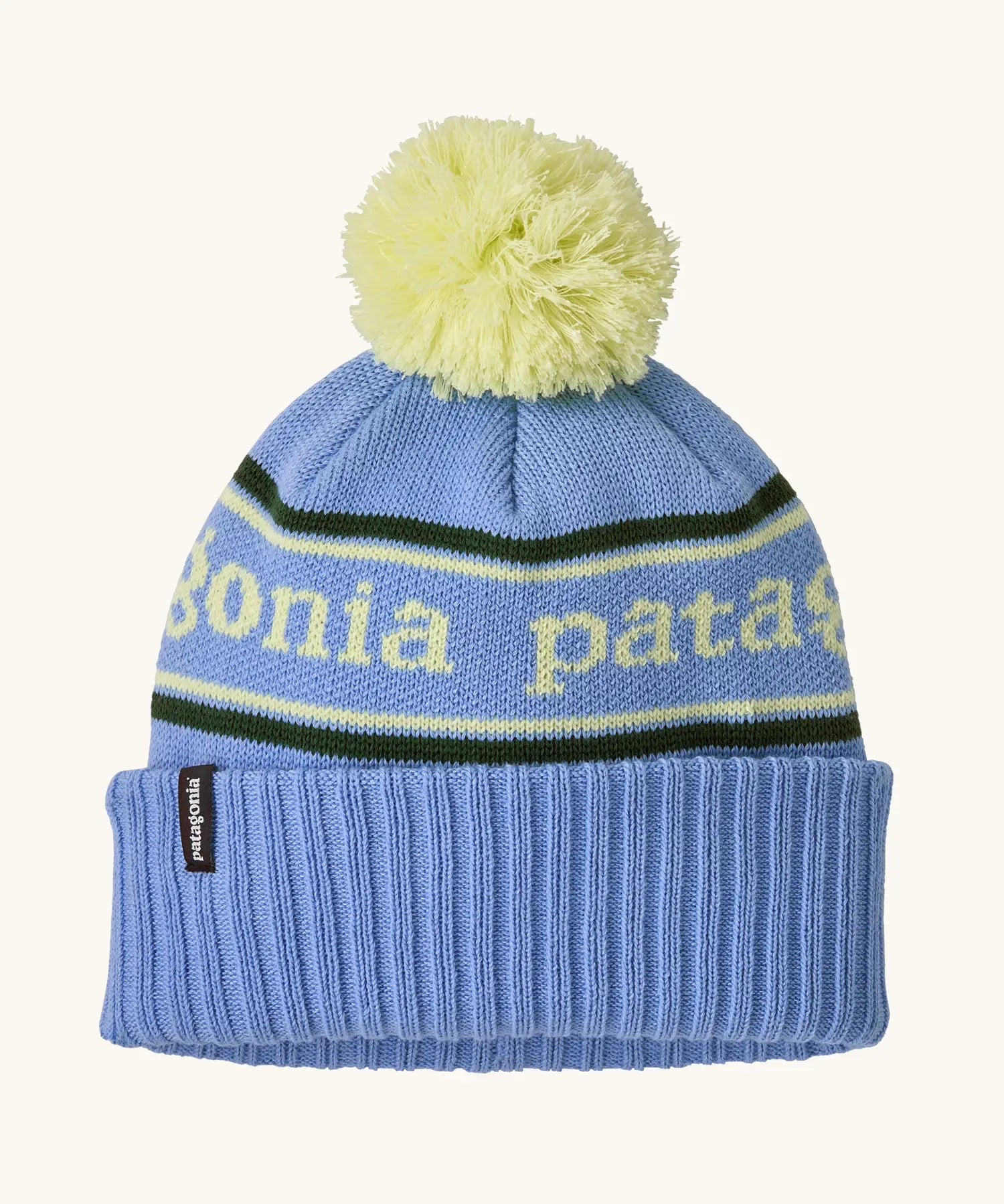 Patagonia Kids Powder Town Beanie in Park Stripe: Diver Blue. A pale blue knit with lime green 'Patagonia' woven around the head, a rib-knit cuff, and a lime green pom-pom on top. 