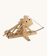 The Walachia Wooden Trebuchet building set, with the movable arm bent back, ready to fire the small wooden ball inside.