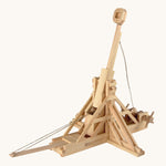 The Walachia wooden Trebuchet building toy, made from wooden parts, on a cream background. The image shows the wooden pieces constructed to make a working DIY Trebuchet