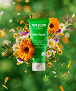 Weleda 30ml moisturising skin food available at Babipur infront of a bright, colourful floral background.