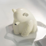 The Oli &amp; Carol Polar Bear Bath Toy Set made from 100% Natural Rubber, stood on its base, floating on water